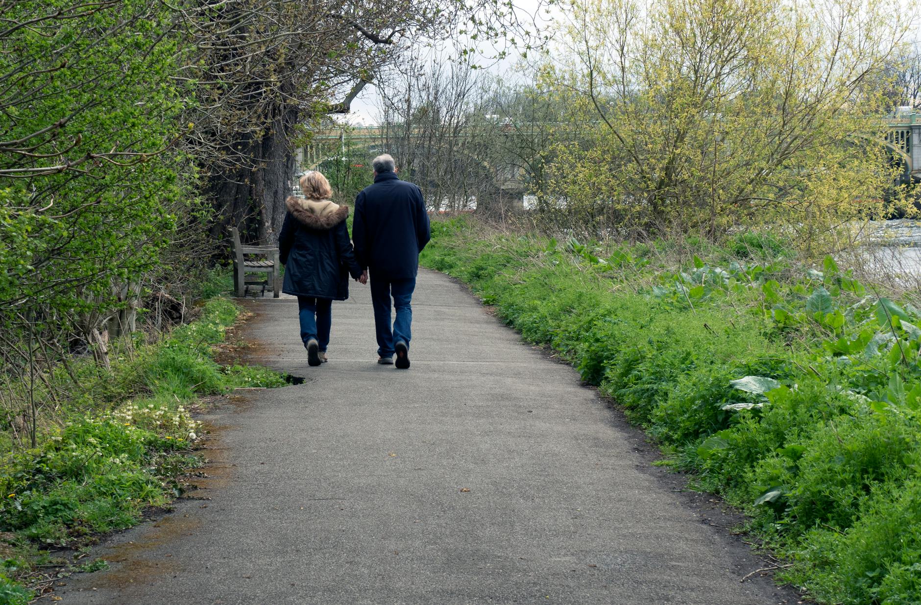 back view of a couple walking hand in hand